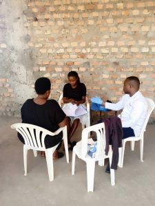 The laboratory technician taking off a blood sample from a client to screen for Diabetes